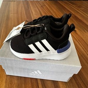 Unisex child racer TR21 Running Shoe. Black, white and blue. New, never worn.